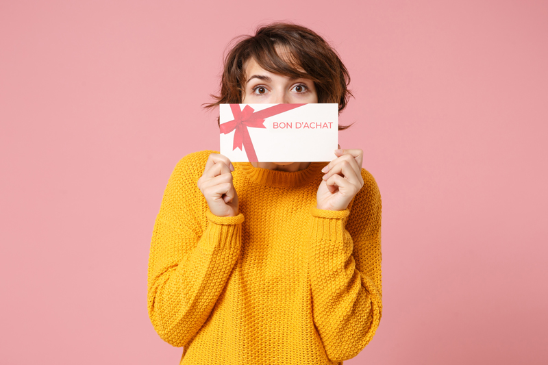 Gestion des dotations de jeu concours - femme tenant un bon d'achat dans ses mains